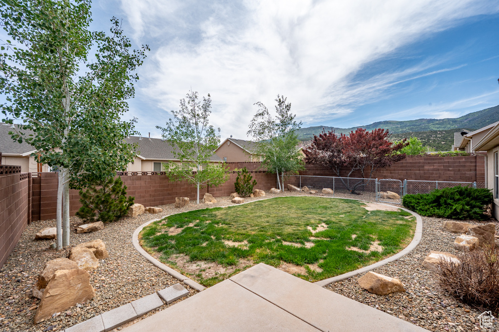 View of yard with a gate and a mountain view