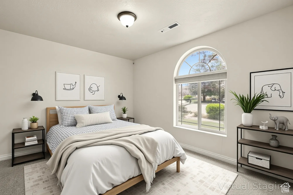 Bedroom featuring light colored carpet and baseboards