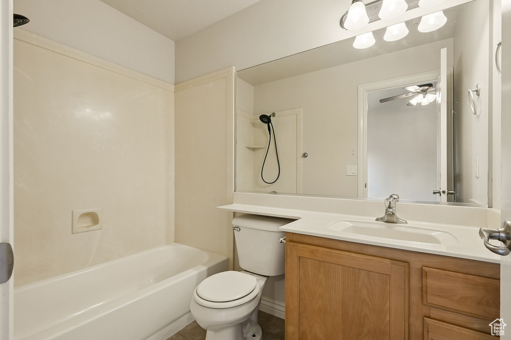 Bathroom with vanity, toilet, tub / shower combination, and a ceiling fan