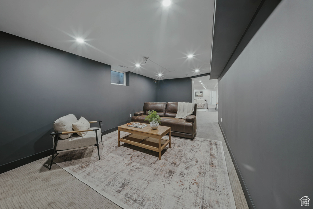 Living area featuring carpet floors and baseboards