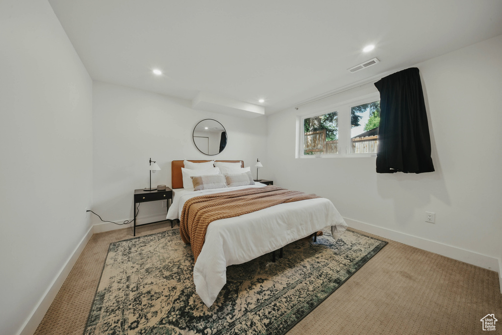 Carpeted bedroom with baseboards and recessed lighting
