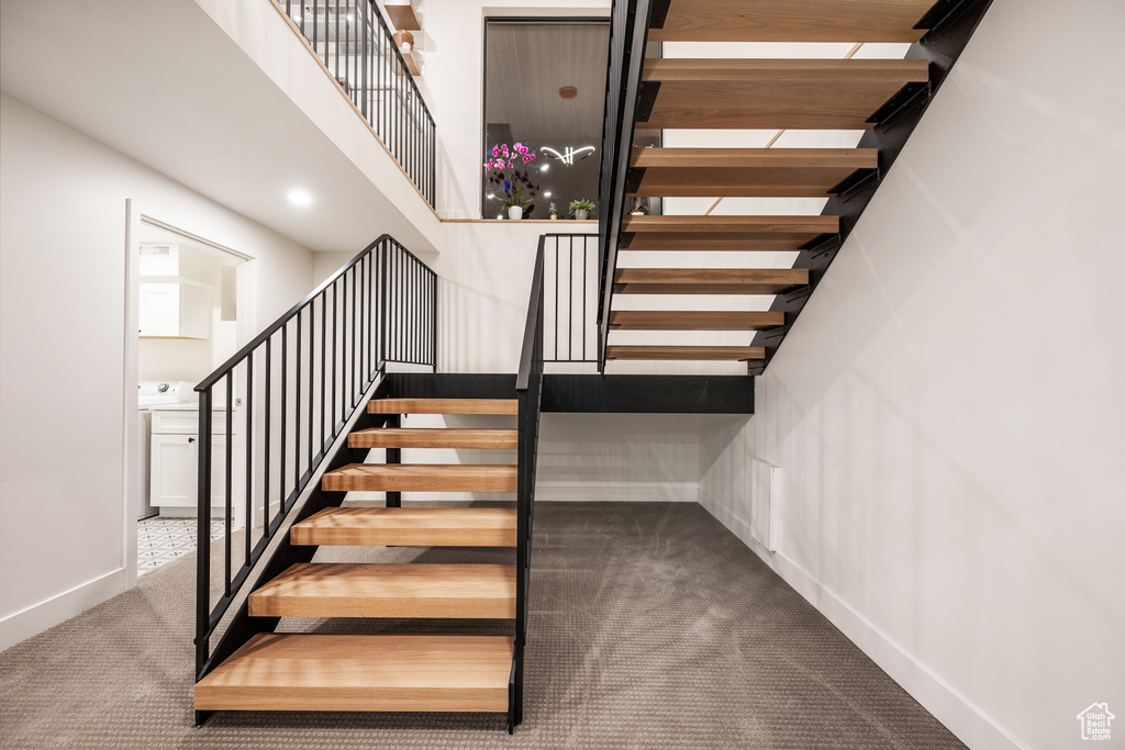 Staircase with carpet floors and baseboards