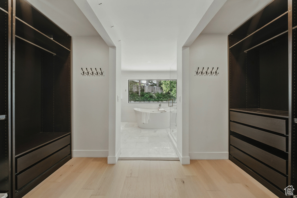 Spacious closet with light wood finished floors