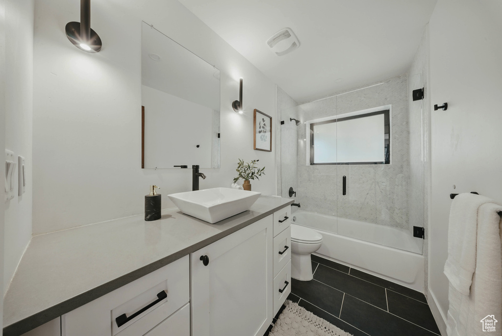 Bathroom featuring vanity, toilet, bathing tub / shower combination, and tile patterned floors