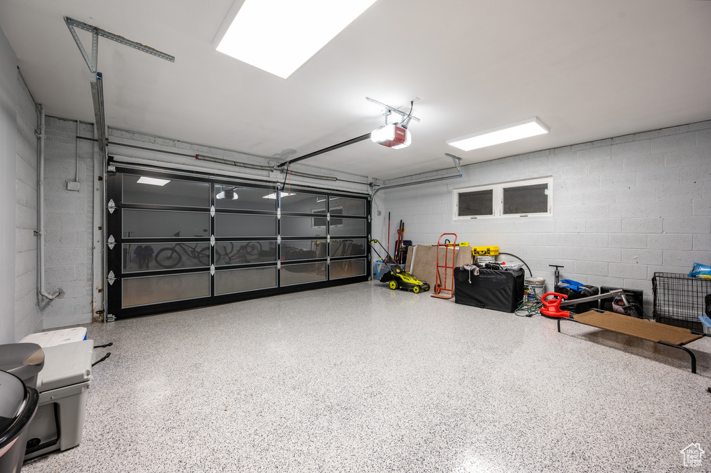 Garage with a garage door opener and concrete block wall
