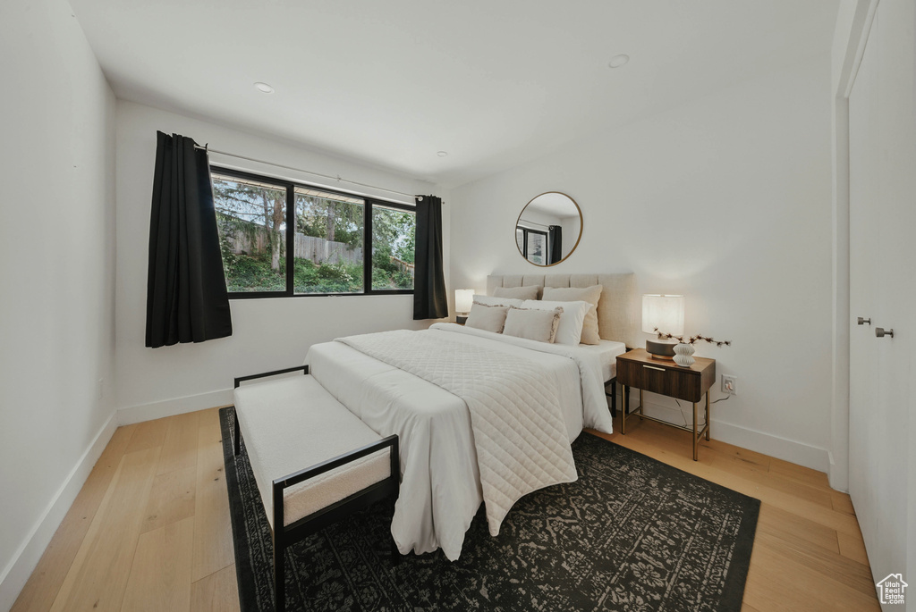 Bedroom featuring light wood-type flooring and baseboards
