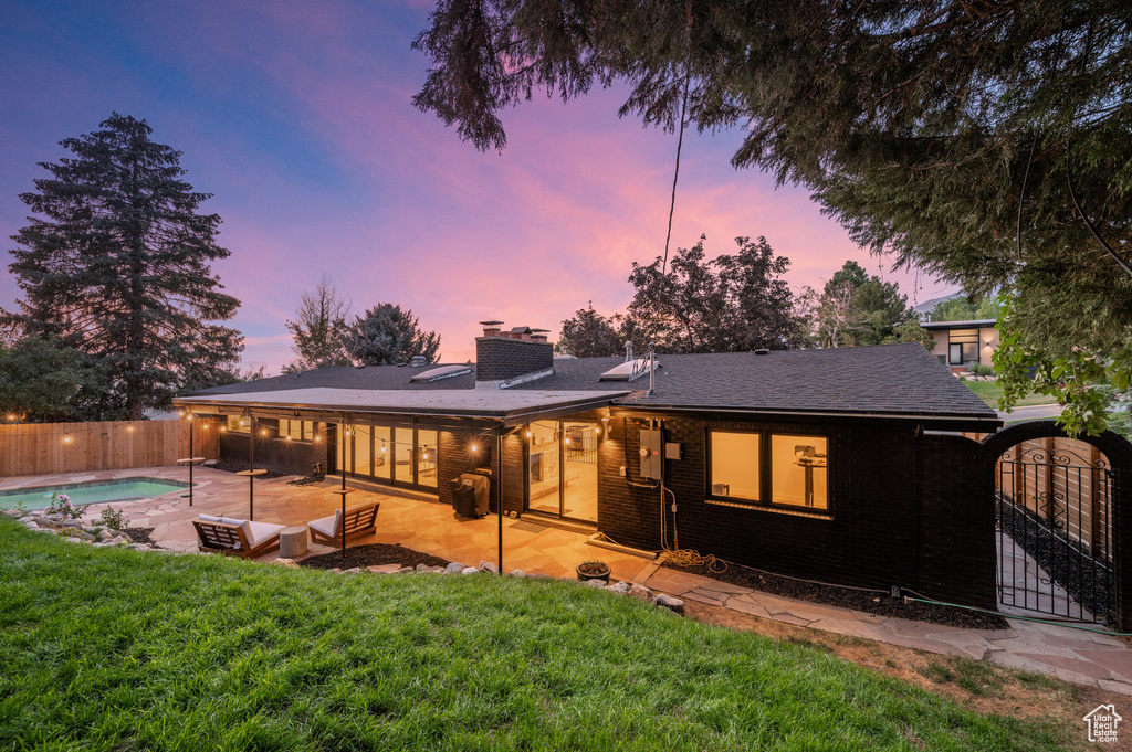 View of front of home with a chimney and a patio area