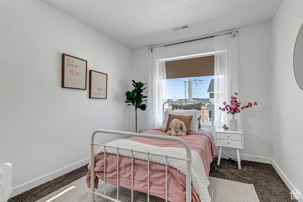 Bedroom featuring carpet floors and baseboards