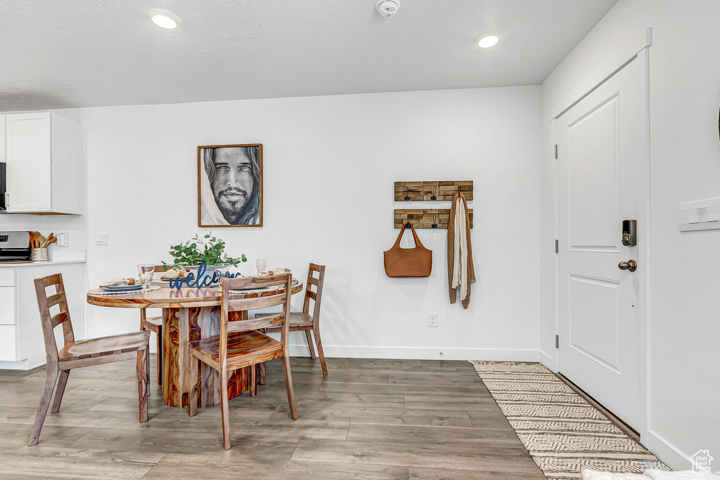 Dining room featuring light wood finished floors, recessed lighting, and baseboards