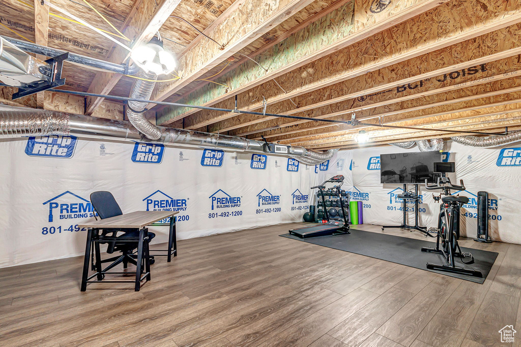 Workout area featuring wood finished floors