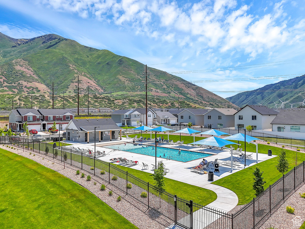 Community pool featuring a patio, a residential view, and a mountain view