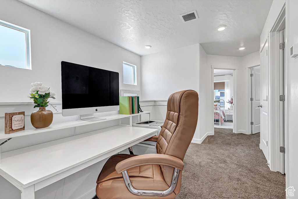 Office area with carpet, a textured ceiling, recessed lighting, and baseboards