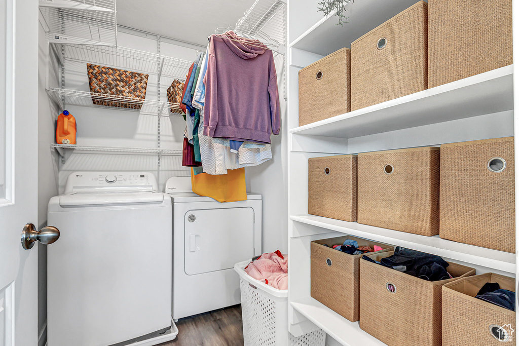 Laundry room with separate washer and dryer and wood finished floors