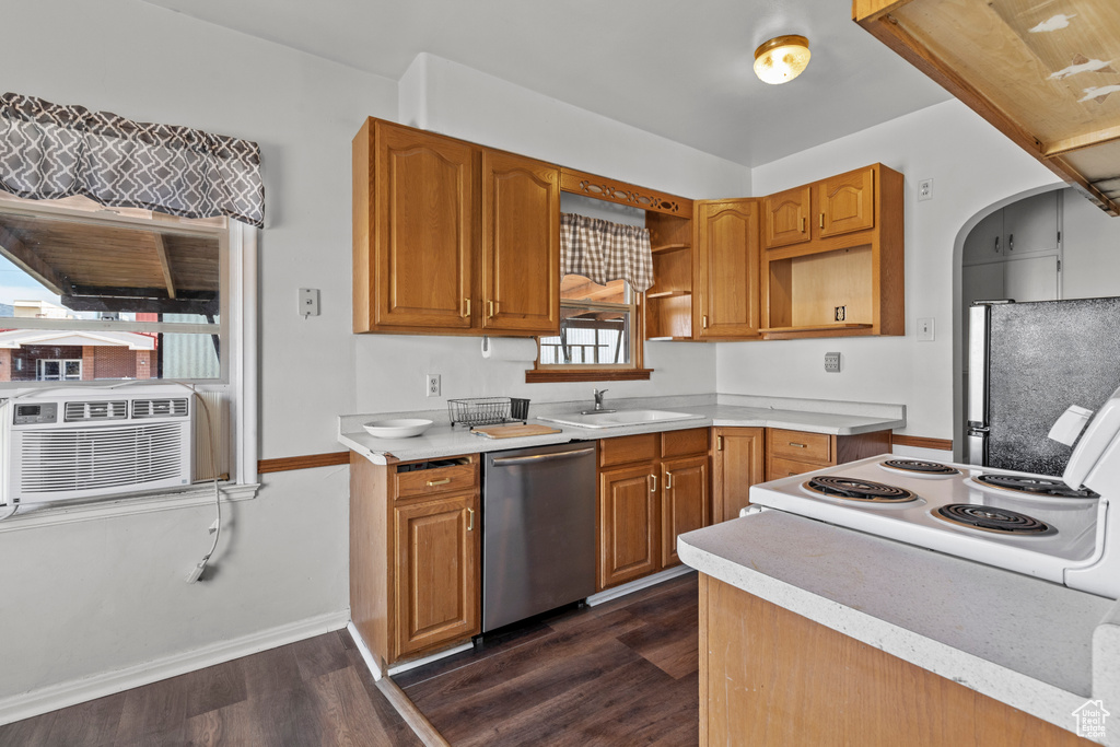 Kitchen featuring appliances with stainless steel finishes, a sink, dark wood-style flooring, open shelves, and baseboards