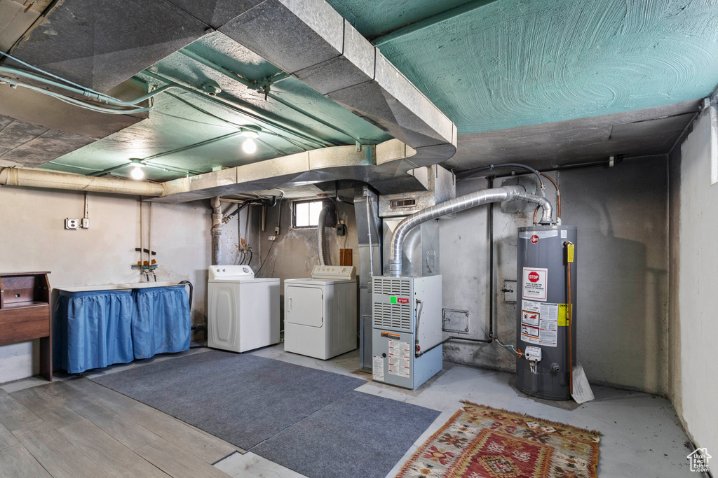 Basement with water heater, washer and clothes dryer, and heating unit