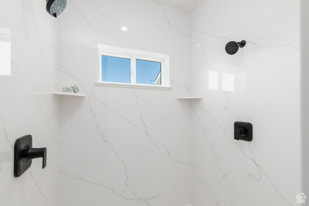 Bathroom view of a marble finish shower
