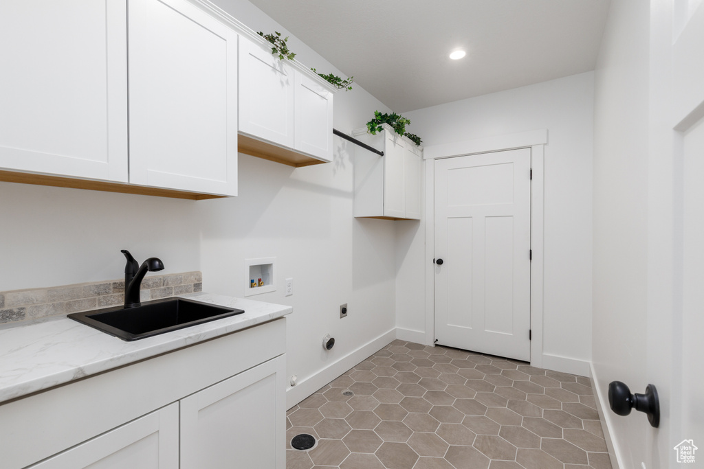 Washroom featuring cabinet space, electric dryer hookup, hookup for a washing machine, recessed lighting, and baseboards