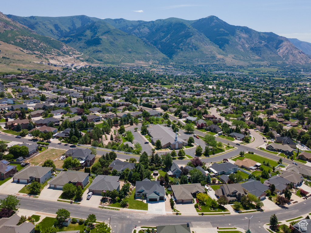 Aerial view of residential area featuring a mountainous background