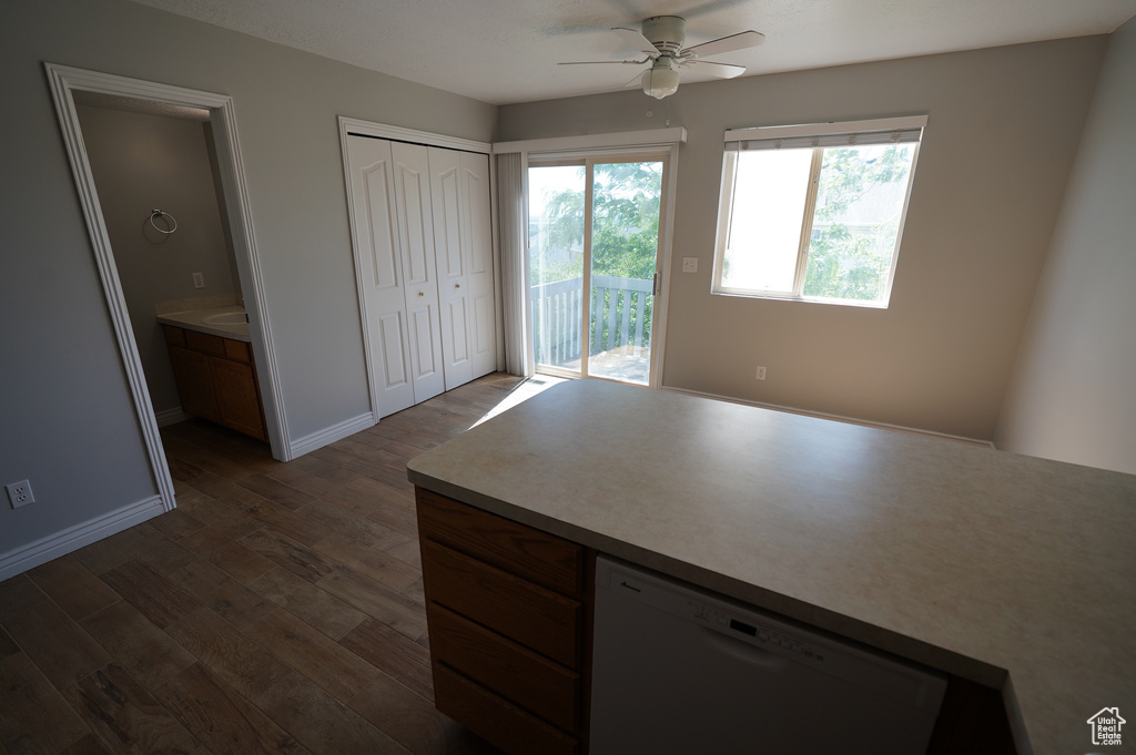 Unfurnished bedroom featuring access to outside, dark wood-style flooring, baseboards, and a ceiling fan