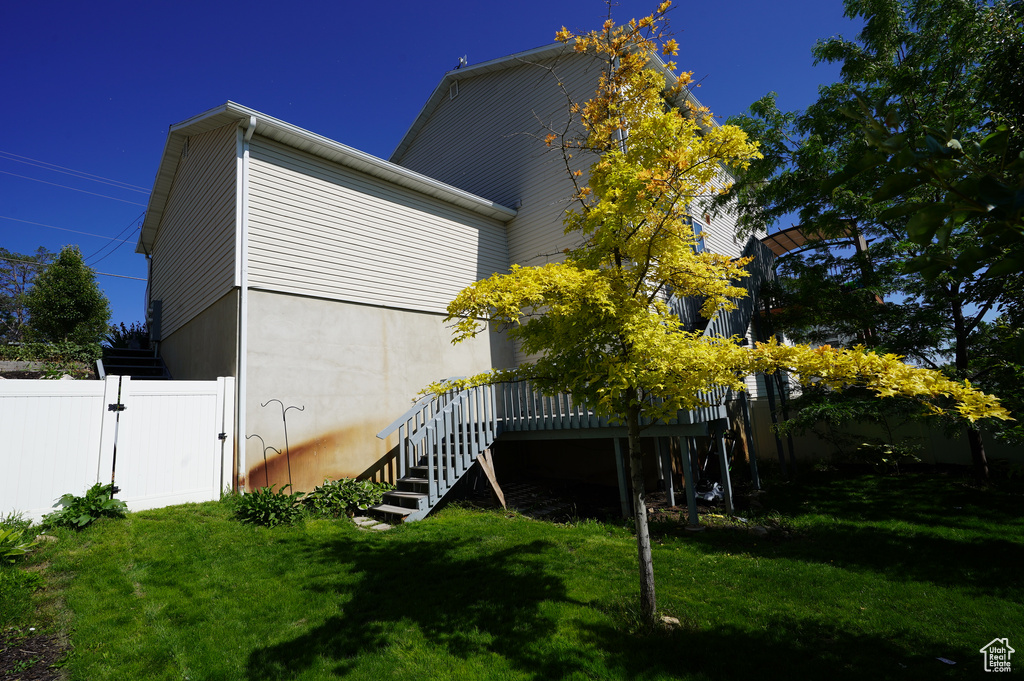 Rear view of house with a gate, stairs, and a wooden deck