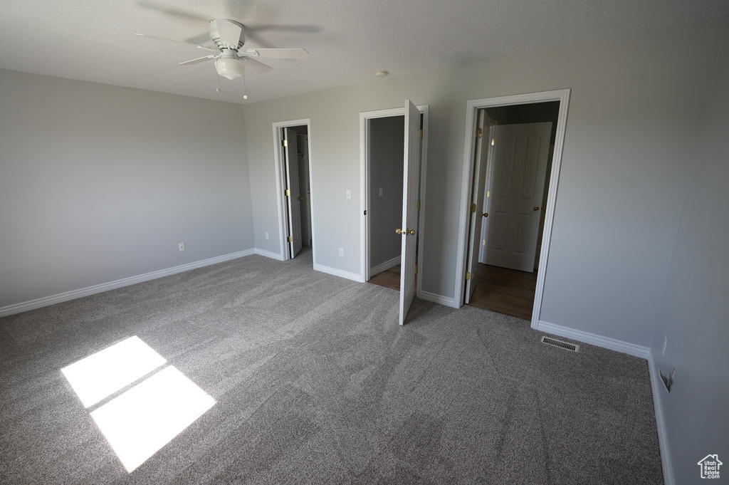 Unfurnished bedroom with carpet floors, baseboards, and a ceiling fan