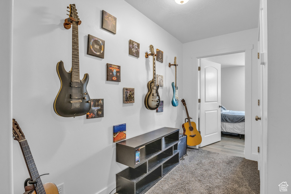 Hallway with baseboards and carpet floors