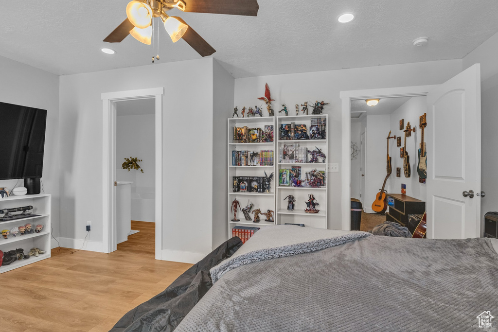 Bedroom featuring light wood-type flooring, baseboards, recessed lighting, and a ceiling fan