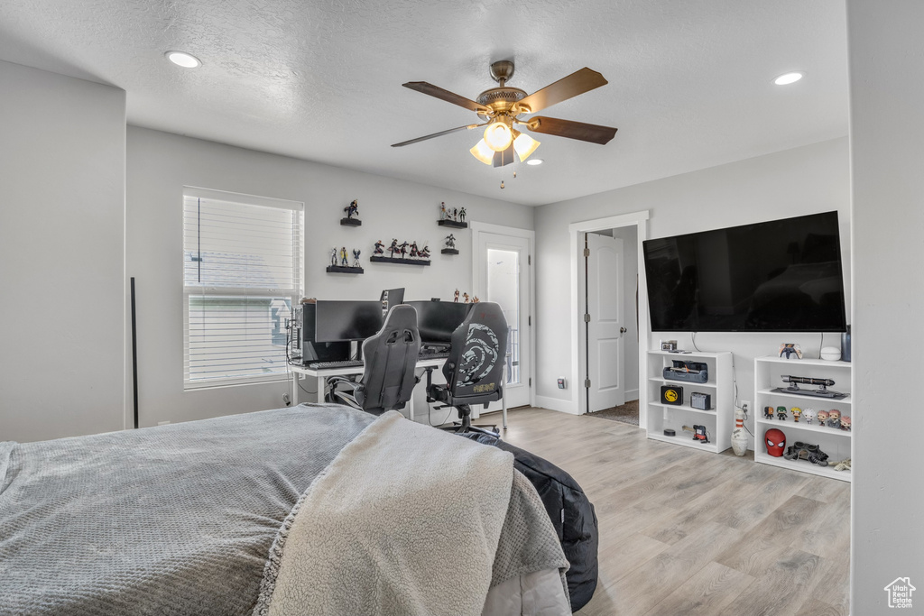 Bedroom featuring wood finished floors, recessed lighting, a ceiling fan, a desk, and baseboards