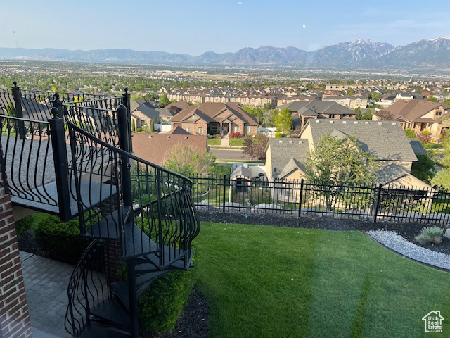 View of yard with a residential view, a mountain view, and stairway