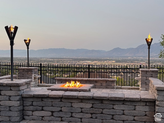 View of patio / terrace featuring an outdoor fire pit and a mountain view
