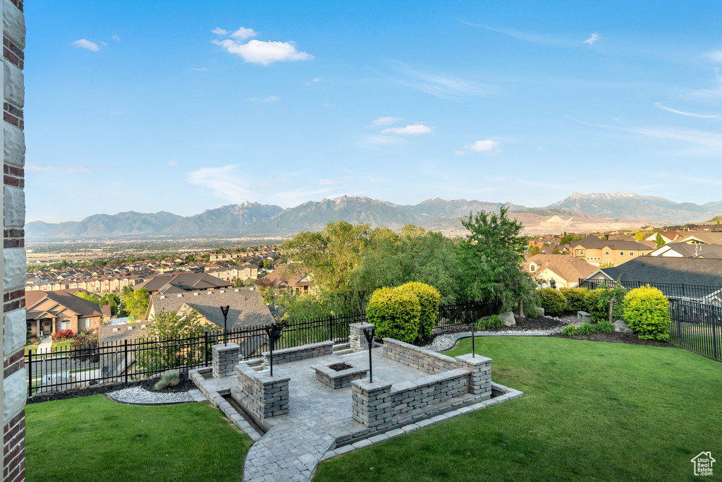 View of yard with a residential view, a mountain view, a patio area, and an outdoor fire pit