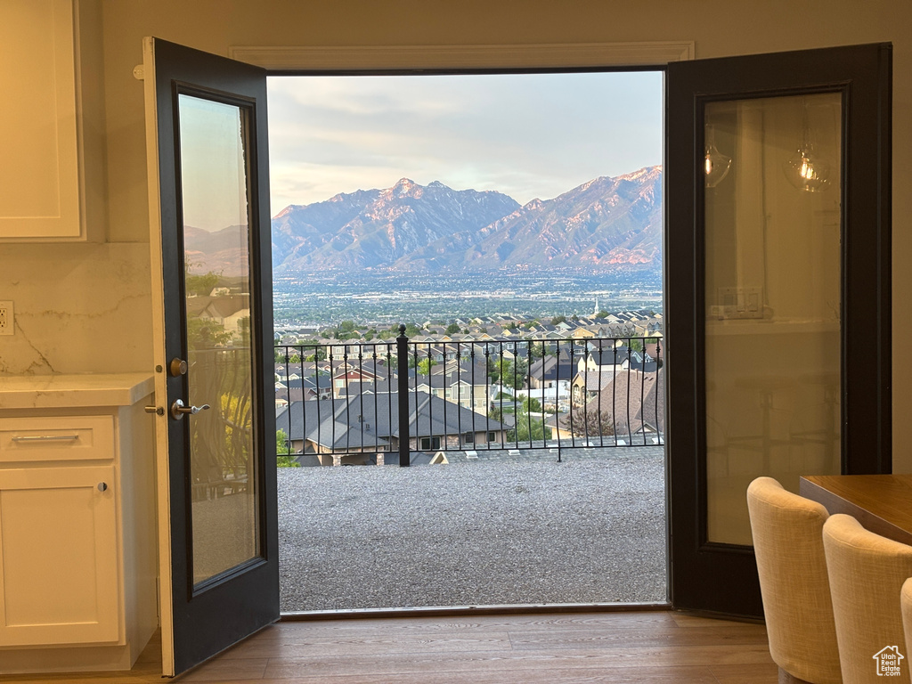 Doorway to outside with wood finished floors and a mountain view