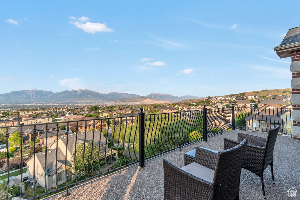 Balcony featuring a residential view and a mountain view
