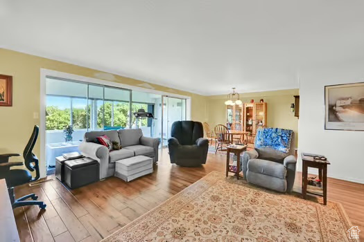 Living room with wood finished floors and a chandelier