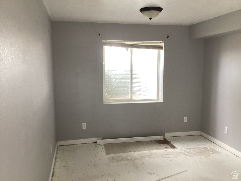 Unfurnished room featuring baseboards