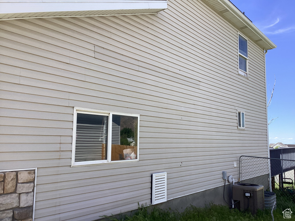 View of side of property with central air condition unit