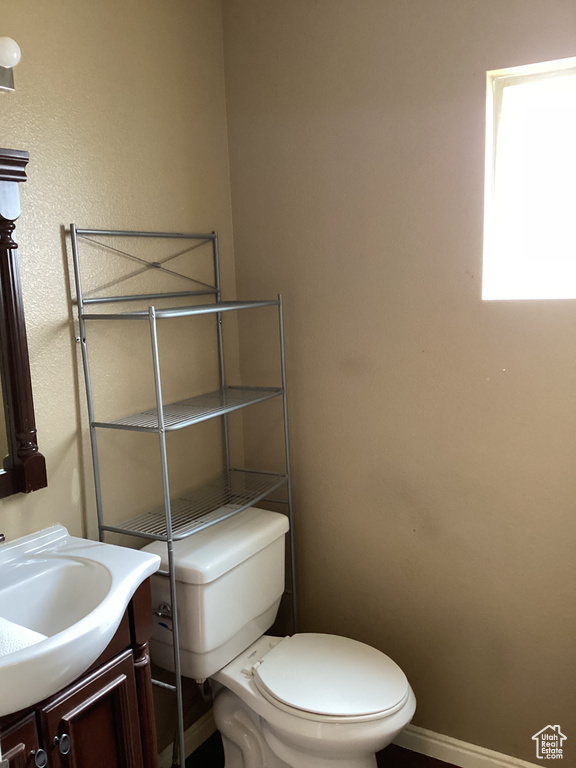 Bathroom with vanity, baseboards, and toilet