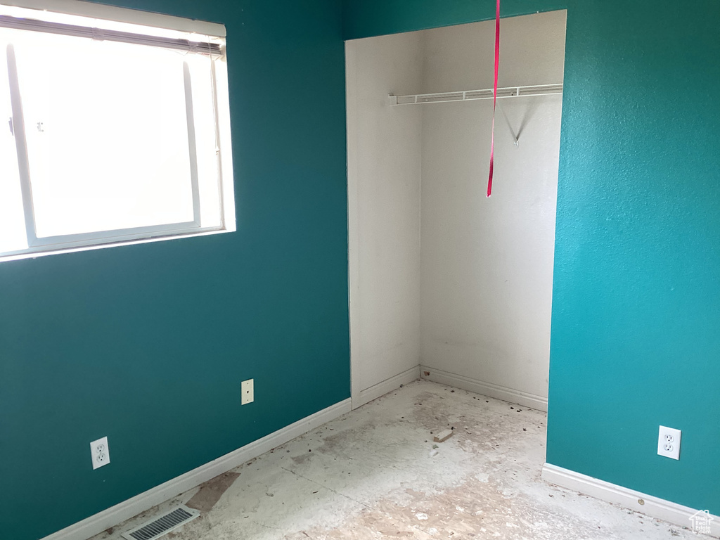 Unfurnished bedroom with baseboards and a closet