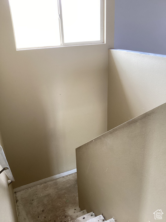 Stairway featuring concrete flooring