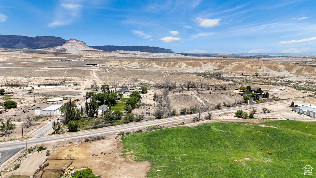 Aerial view of sparsely populated area featuring a mountain backdrop and a desert landscape