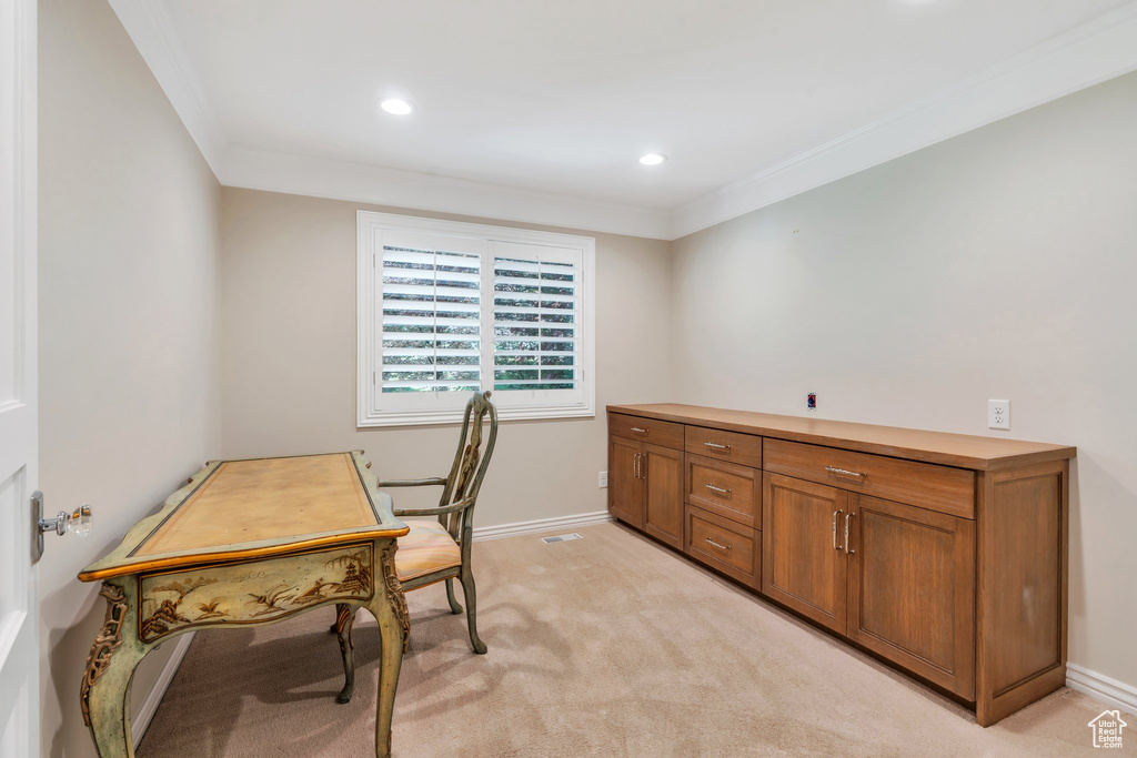 Office space with crown molding, baseboards, recessed lighting, and light carpet
