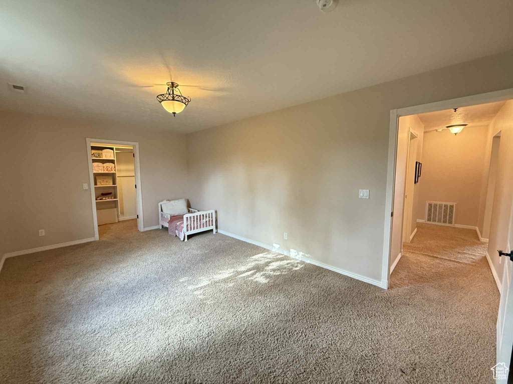 Spare room featuring carpet flooring and baseboards
