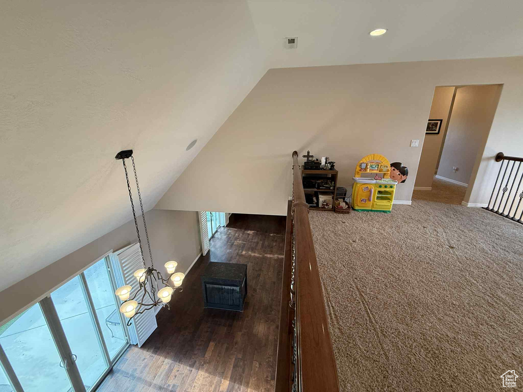 Staircase with lofted ceiling, baseboards, wood finished floors, and recessed lighting