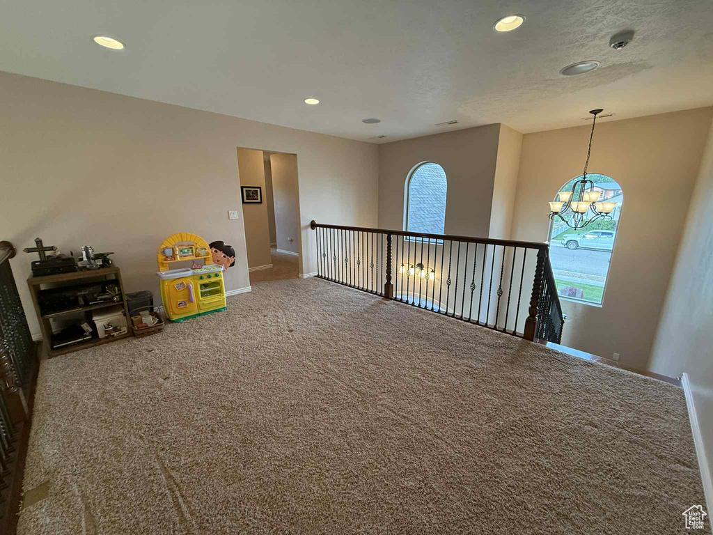 Rec room featuring carpet flooring, baseboards, recessed lighting, and a chandelier