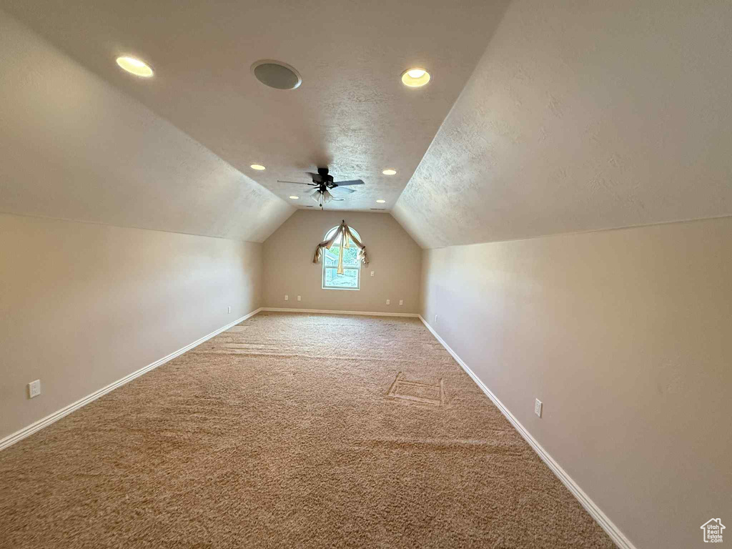 Bonus room featuring carpet, lofted ceiling, baseboards, recessed lighting, and a textured ceiling