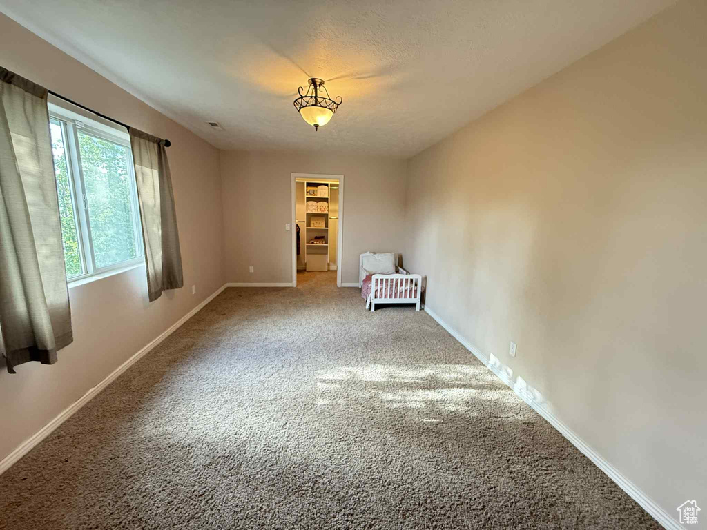 Unfurnished room featuring carpet and baseboards