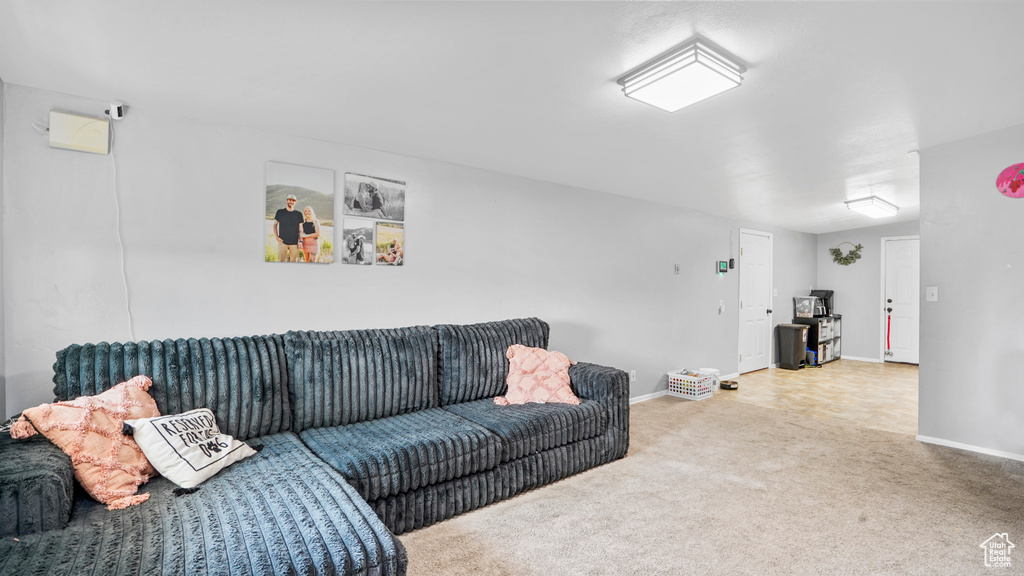 Carpeted living room with baseboards
