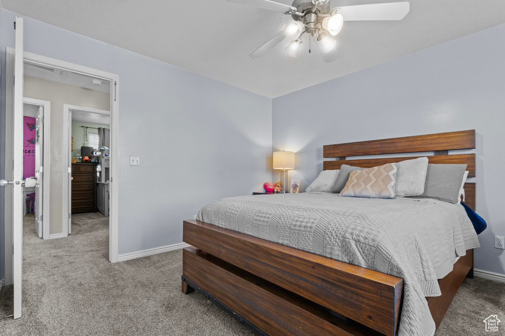 Carpeted bedroom with baseboards and ceiling fan