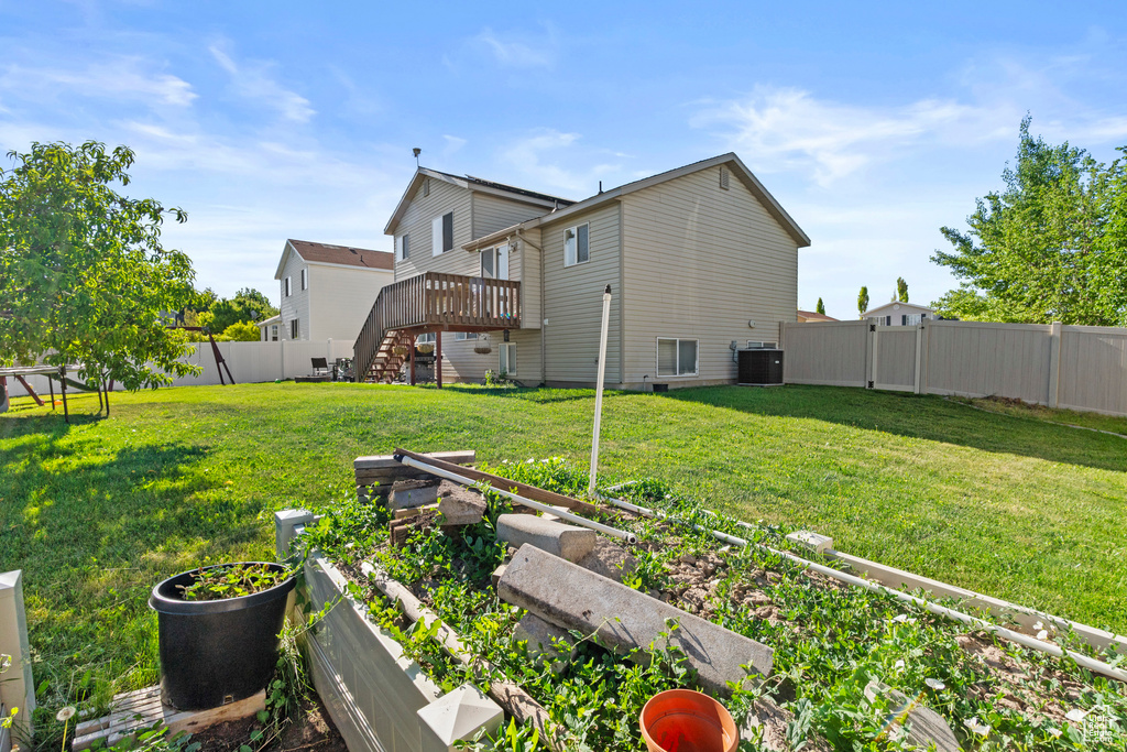 Back of house with a garden, central AC, stairway, and a deck