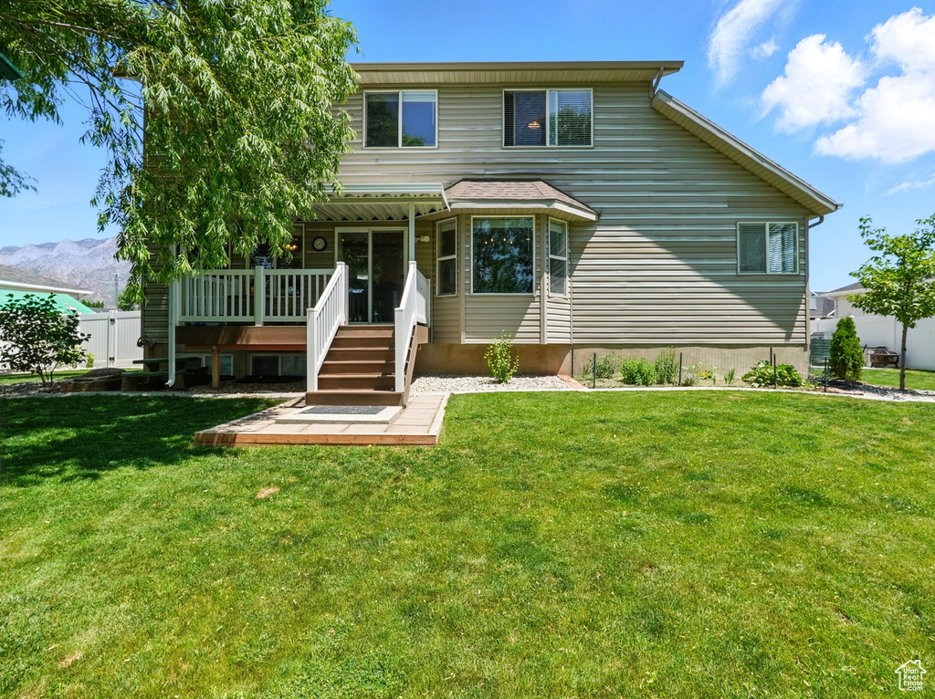View of front of house with a deck with mountain view